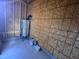 Utility room featuring a water tank, paint cans, and wood paneling at 4553 Dedication Dr, Raleigh, NC 27610