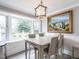 Bright dining room with a table for four, window seat, and view of the backyard at 505 Harvard St, Raleigh, NC 27609