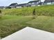 Large, grassy backyard on a sloped lot offers ample space between homes in the community at 105 Windchime Ct, Fuquay Varina, NC 27526