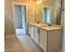Bathroom with a double sink vanity offers extra counter space and storage and an entrance to the walk-in closet at 105 Windchime Ct, Fuquay Varina, NC 27526