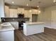 Bright kitchen features white cabinets, stainless appliances, granite counters, and an island with pendant lighting at 105 Windchime Ct, Fuquay Varina, NC 27526