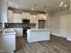 Kitchen with island, stainless steel appliances, tile backsplash and pendant lighting at 105 Windchime Ct, Fuquay Varina, NC 27526