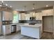 Well-lit kitchen with white cabinets, quartz countertops, tile backsplash and stainless steel appliances at 105 Windchime Ct, Fuquay Varina, NC 27526