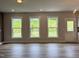 Open floor plan with three windows allowing for natural light into the large living area at 105 Windchime Ct, Fuquay Varina, NC 27526