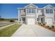 Newly constructed townhome showcases a single-car garage, manicured lawn and convenient driveway at 305 Cherry Laurel Dr, Sanford, NC 27332