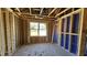 A framed bedroom with visible framing, wiring, and a window overlooking the outdoors at 3852 Well Fleet Drive, Willow Springs, NC 27592