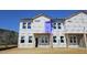 New townhome exterior with visible framework and windows, ready for finishing touches and occupancy at 3852 Well Fleet Drive, Willow Springs, NC 27592