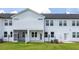 Backyard of a two-story home with white siding, a screened porch, and a well-maintained lawn at 3856 Well Fleet Drive, Fuquay Varina, NC 27526