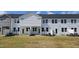 Townhome backyard features a patio and freshly installed sod, perfect for outdoor enjoyment at 3856 Well Fleet Drive, Fuquay Varina, NC 27526