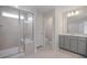 Neutral bathroom with tiled shower, glass door, and vanity with gray cabinets at 3856 Well Fleet Drive, Fuquay Varina, NC 27526