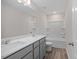 Bathroom featuring double sinks, a large mirror, modern fixtures, and a shower-tub combo at 3856 Well Fleet Drive, Fuquay Varina, NC 27526