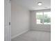 Bright bedroom with neutral carpet and a large window, featuring a recessed light at 3856 Well Fleet Drive, Fuquay Varina, NC 27526