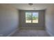Unfinished bedroom featuring a window providing natural light and views of the outdoors at 3856 Well Fleet Drive, Fuquay Varina, NC 27526