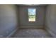 Unfinished bedroom features a window offering natural light and scenic outdoor views at 3856 Well Fleet Drive, Fuquay Varina, NC 27526