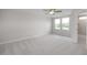 Spacious bedroom with large windows, plush carpeting, ceiling fan, and an en-suite bathroom at 3856 Well Fleet Drive, Fuquay Varina, NC 27526