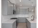 A bright kitchen featuring gray cabinets, a stainless steel range, and white countertops and backsplash at 3856 Well Fleet Drive, Fuquay Varina, NC 27526
