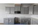 A kitchen featuring gray cabinets, white subway tile backsplash, and stainless appliances at 3856 Well Fleet Drive, Fuquay Varina, NC 27526