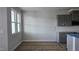 A sunlit kitchen area with grey cabinets and a window, ready for appliances at 3856 Well Fleet Drive, Fuquay Varina, NC 27526