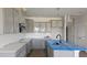 A bright kitchen with gray cabinets, stainless appliances, and a central island at 3856 Well Fleet Drive, Fuquay Varina, NC 27526