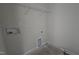 Unfinished laundry room with shelf, hookups, and space for washer and dryer at 3856 Well Fleet Drive, Fuquay Varina, NC 27526