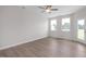 Open-concept living area with hardwood floors, a ceiling fan, and an outdoor access door at 3856 Well Fleet Drive, Fuquay Varina, NC 27526