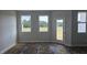 An unfinished living room featuring ample sunlight from the windows and access to the backyard at 3856 Well Fleet Drive, Fuquay Varina, NC 27526