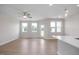 Open-concept living area with hardwood floors, a ceiling fan, and a bright and airy ambiance at 3856 Well Fleet Drive, Fuquay Varina, NC 27526
