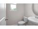 Powder room featuring a pedestal sink, tiled floors, and a window providing natural light at 3856 Well Fleet Drive, Fuquay Varina, NC 27526