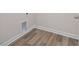 Neutral-toned room features vinyl plank flooring and white trim with an access box at 3856 Well Fleet Drive, Fuquay Varina, NC 27526