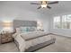 Bright bedroom featuring a large bed, soft carpet, and windows providing ample natural light at 3856 Well Fleet Drive, Fuquay Varina, NC 27526