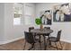 Modern dining area with a round table, stylish chairs, and natural light through a large window at 3856 Well Fleet Drive, Fuquay Varina, NC 27526