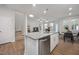 Modern kitchen island with stainless steel dishwasher overlooking the living area and breakfast nook at 3856 Well Fleet Drive, Fuquay Varina, NC 27526