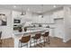 Modern kitchen with white cabinets, stainless steel appliances, an island, and pendant lighting at 3856 Well Fleet Drive, Fuquay Varina, NC 27526