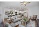 Open-concept living room with modern furnishings and wood flooring leading to the contemporary kitchen at 3856 Well Fleet Drive, Fuquay Varina, NC 27526