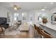 Cozy living room with stylish seating, a large TV, and a breakfast bar that connects to the kitchen at 3856 Well Fleet Drive, Fuquay Varina, NC 27526