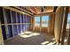 Bedroom under construction featuring exposed framing, a large window and unfinished floors at 3858 Well Fleet Drive, Willow Springs, NC 27592