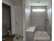 Modern tiled shower featuring a built-in bench and natural light from a small window at 3928 Well Fleet Drive, Fuquay Varina, NC 27526