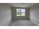 Bedroom features neutral walls, white trim, baseboard trim, and a window with a view at 3928 Well Fleet Drive, Fuquay Varina, NC 27526
