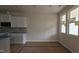 New kitchen features white cabinets, gray backsplash, and lots of natural light at 3928 Well Fleet Drive, Fuquay Varina, NC 27526