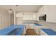 New kitchen features white cabinets, stainless steel appliances, and an island with covered countertops at 3928 Well Fleet Drive, Fuquay Varina, NC 27526