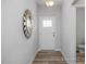 The foyer welcomes you with wood floors, a decorative mirror, and a view of the powder room at 3928 Well Fleet Drive, Fuquay Varina, NC 27526