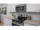 Stainless steel range and microwave in the kitchen at 3928 Well Fleet Drive, Fuquay Varina, NC 27526