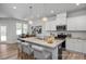 Kitchen featuring a large island with seating and modern lighting at 3928 Well Fleet Drive, Fuquay Varina, NC 27526