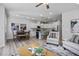 Open-concept living room features modern decor, ceiling fan, and a view of the kitchen at 3928 Well Fleet Drive, Fuquay Varina, NC 27526