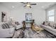 Relaxing living room with stylish furniture, ceiling fan, and ample natural light at 3928 Well Fleet Drive, Fuquay Varina, NC 27526