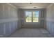 Cozy bedroom with fresh drywall, a window providing an outdoor view ready for customization at 3930 Well Fleet Drive, Fuquay Varina, NC 27526
