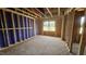 Unfinished bedroom with exposed framing, a window view, and an open layout at 3932 Well Fleet Drive, Fuquay Varina, NC 27526