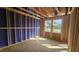 Bedroom under construction featuring exposed framing, dual windows and natural light at 3932 Well Fleet Drive, Fuquay Varina, NC 27526