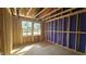 New construction shows the room framing and two windows ready for finishing with a view of the outdoors at 3932 Well Fleet Drive, Fuquay Varina, NC 27526