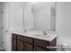 Bathroom with a double sink vanity, brown cabinets, large mirrors, and a toilet to the side at 3932 Well Fleet Drive, Fuquay Varina, NC 27526